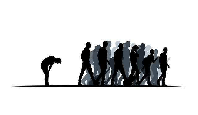 a man leans over tired while the crowd is far ahead